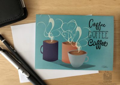 Teal background with three coffee mugs, one dark blue, one coral pink, and one blue gray, with steam and the words "Coffee Coffee Coffee" in three different fonts to the right of the steaming mugs