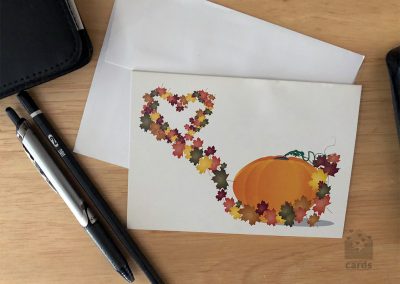 White Background with Pumpkin and Fall Leaves swirling into heart